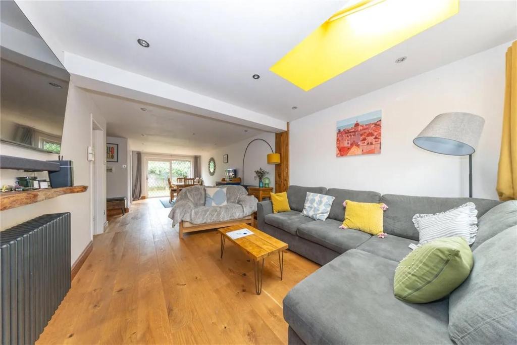 a living room with a couch and a table at Entire 3 bedroom house in Luton