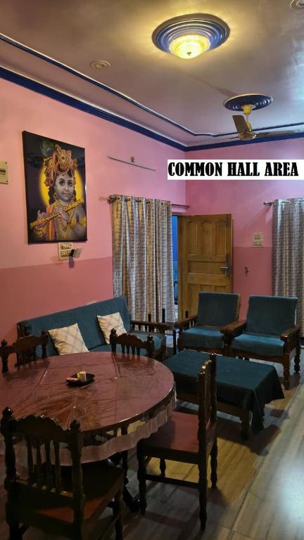 a room with a couch and a table and chairs at Shree niwas- Blue Room in Bokāro