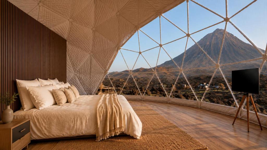 a bedroom with a bed and a view of a mountain at Sodade Eco Camp in Portela