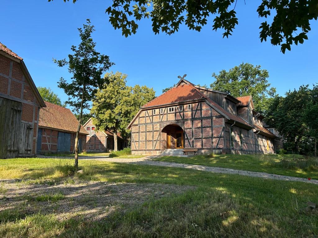 an old stone barn with a red roof at Herberge am Mönchsbruch in Gerdau