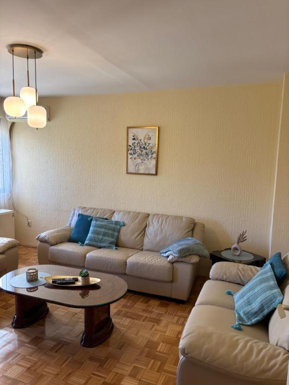 a living room with a couch and a table at Sweet dreams apartment in Bar