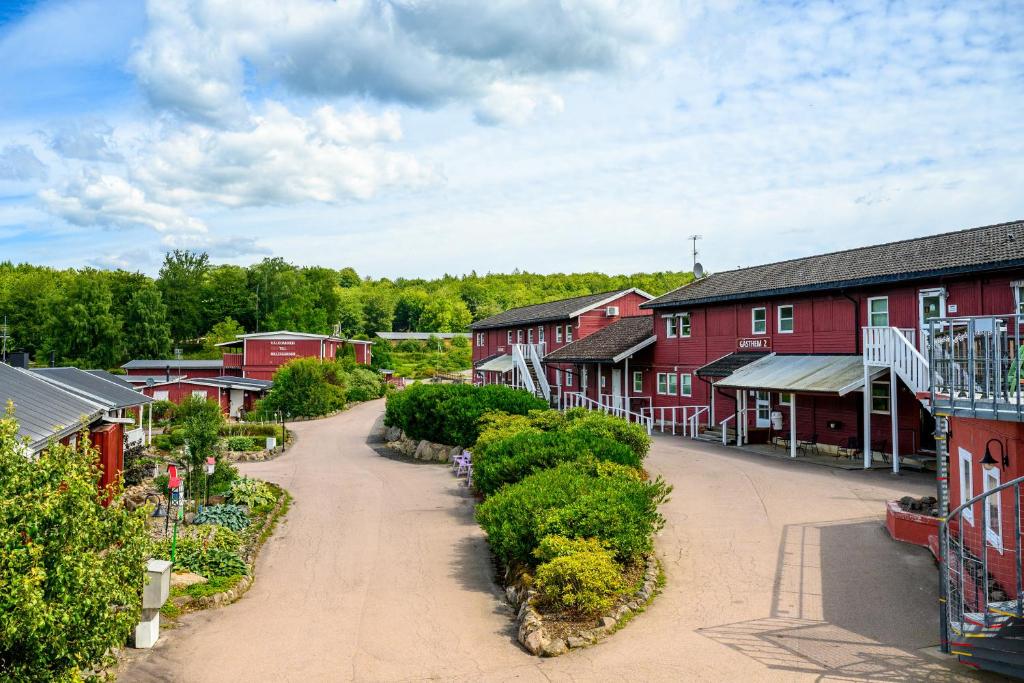 a village with red houses and a dirt road at Hillesgården in Boarp