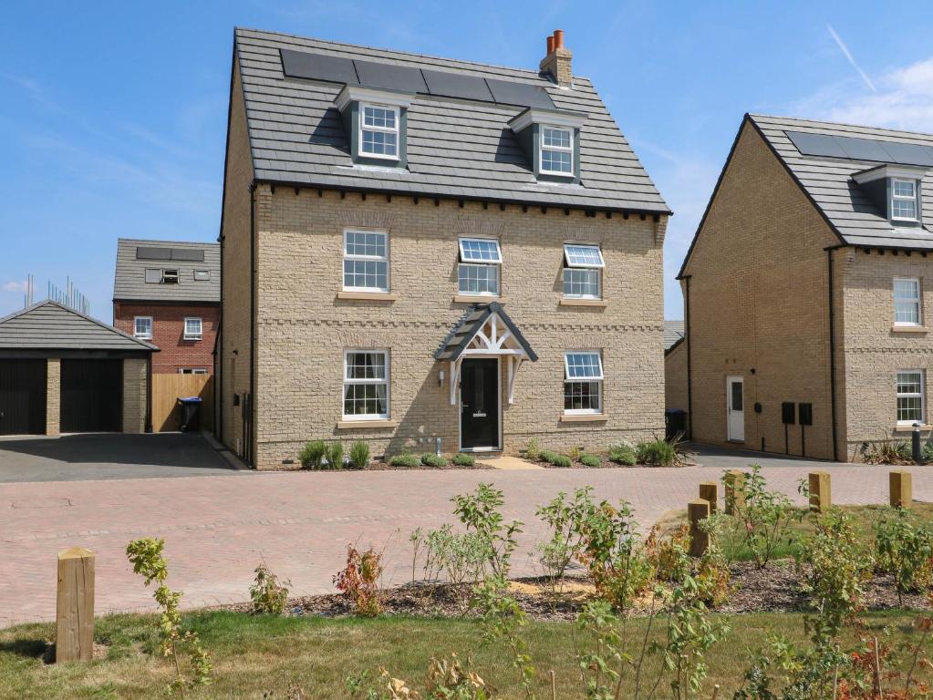 a large brick house with a gambrel roof at Stepping Stone in Ashbourne