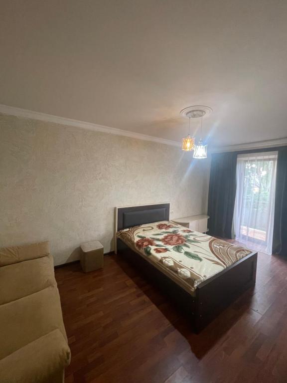 a bedroom with a bed and a couch at Poti apartment in Poti