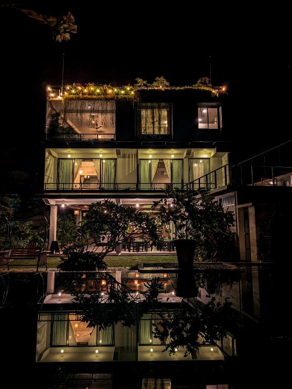 a night view of a building with lights at Ivory Resort Dikwella in Dickwella