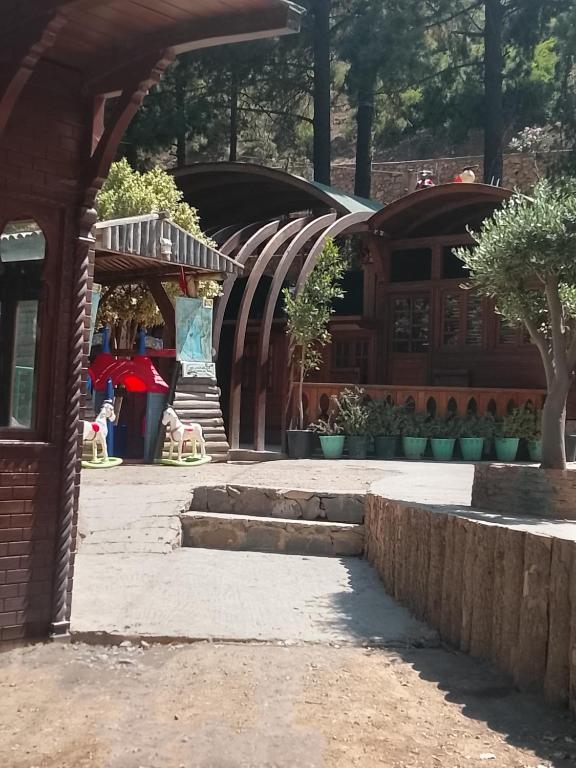 a courtyard of a building with some trees and buildings at مخيم اقشور in Chefchaouen