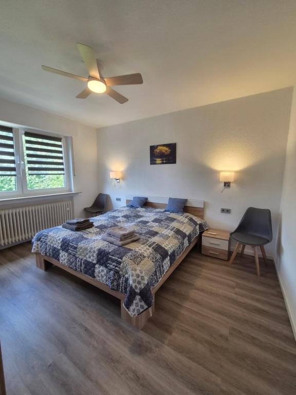 a bedroom with a bed and a ceiling fan at FeWo Marjenza in Wermelskirchen