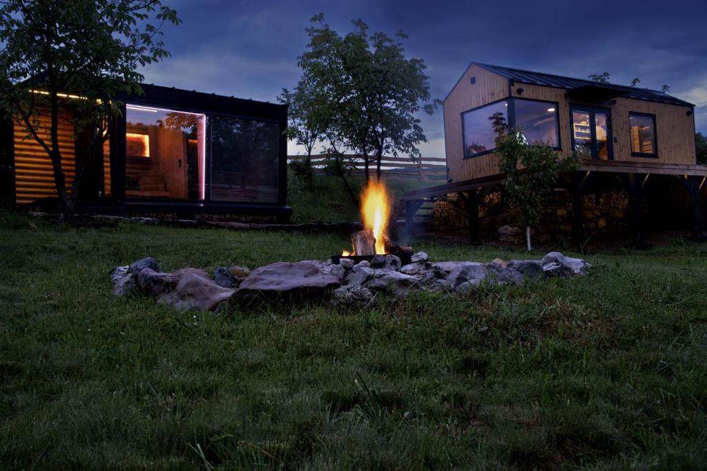 a fire pit in front of a tiny house at Gradmina Glamping Retreat in Prevala