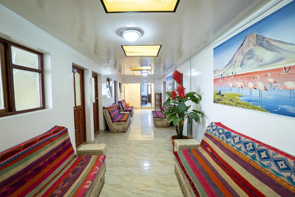 a hallway with benches and a painting on the wall at Hostal Terra Sal - Bed, Breakfast, Garage & Salar de Uyuni Tours in Uyuni