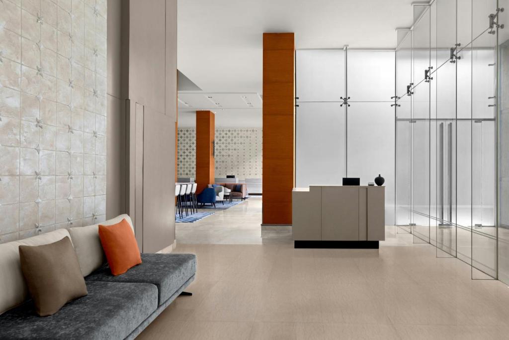 A quiet lobby seating corner beside a glass-walled reception area.