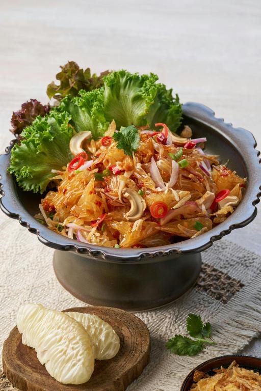 A Thai-style salad with glass noodles, vegetables, herbs and fruit on the side.