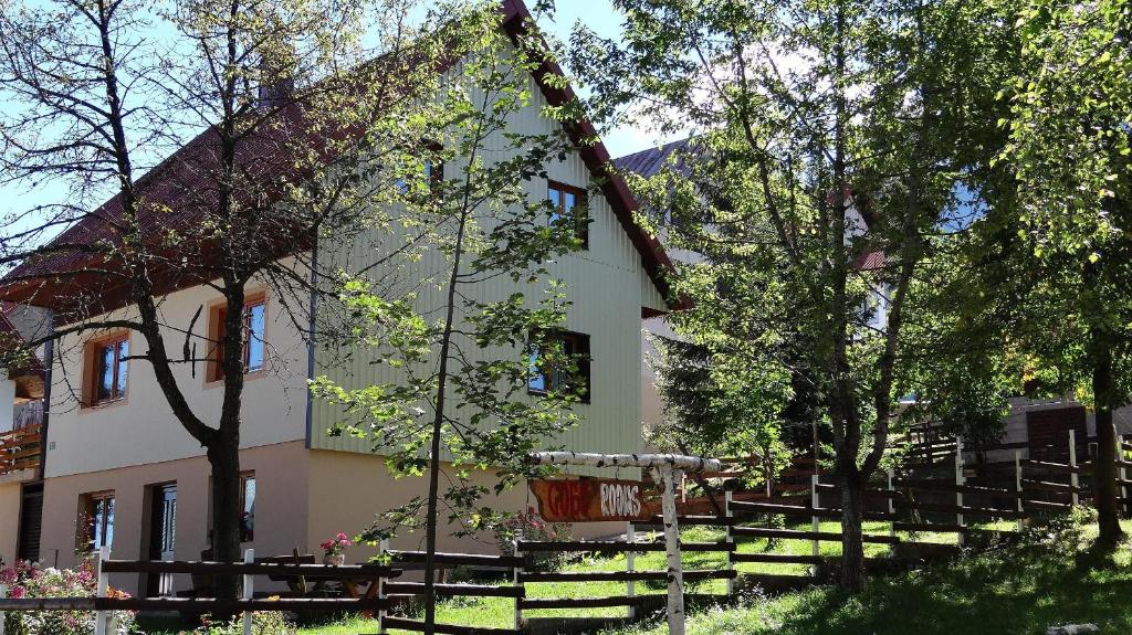 a building with trees in front of it at Guest House Milena in Žabljak