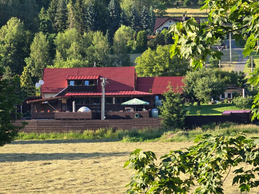 a house with a red roof in a field at Wellness-Beskydy in Prostřední Bečva