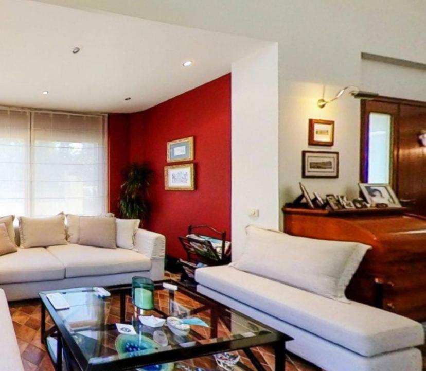a living room with two white couches and a piano at Ta'Casa in Xàtiva