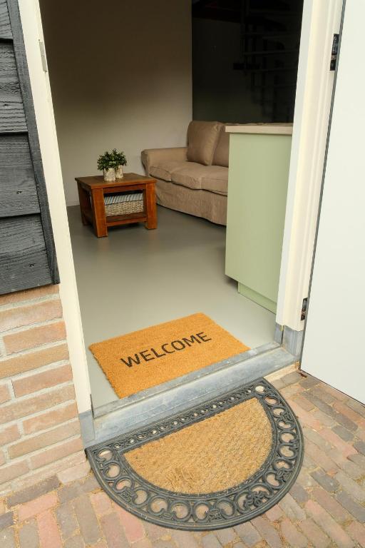 a living room with a welcome mat in the doorway at B&B by lin in Dodewaard