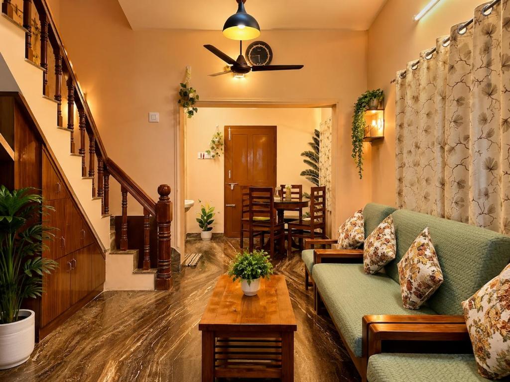 a living room with a couch and a table at Blue home stay- 10min walk to kanyakumari beach in Kanyakumari