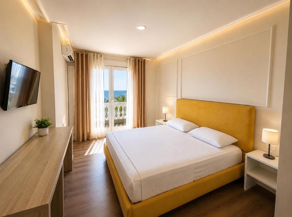 a hotel room with a bed and a window at Shala Resort & SPA in Durrës