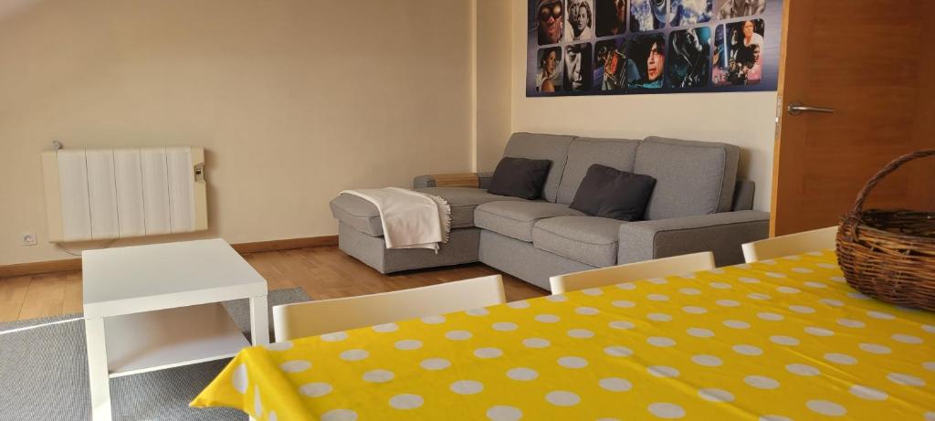 a living room with a couch and a table at Atico en Carnota para 4 personas in Vilar