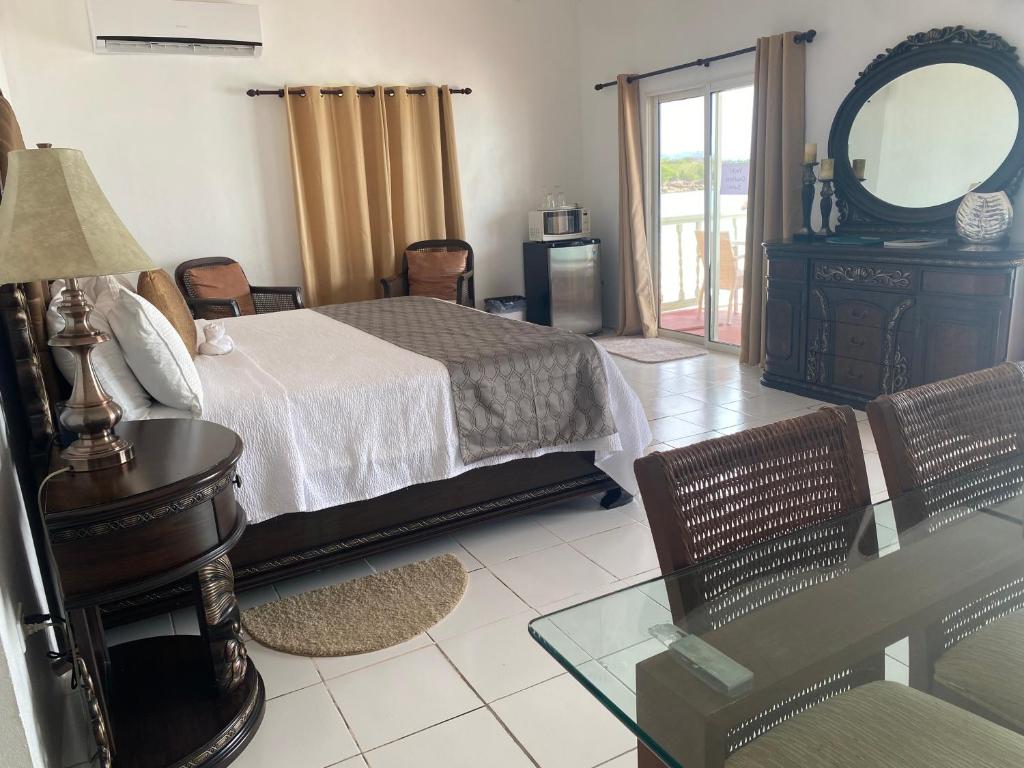a bedroom with a bed and a table and a mirror at Rendezvous Bay Hotel in Lower South Hill