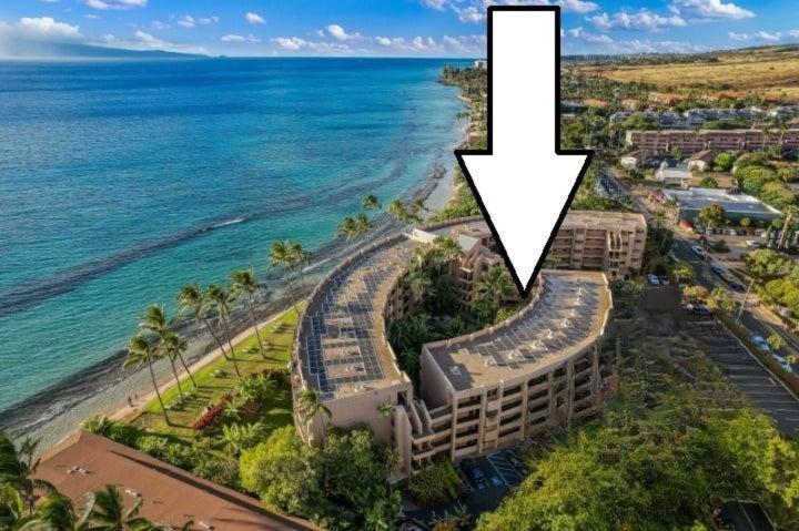 an aerial view of a hotel and the beach at Paki Maui 217 · PM 217 Cozy 1BR Oceanfront Condo w Pool in Lahaina