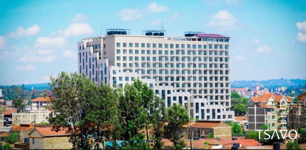 a large white building in the middle of a city at Unique one bedroom with pool in Nairobi
