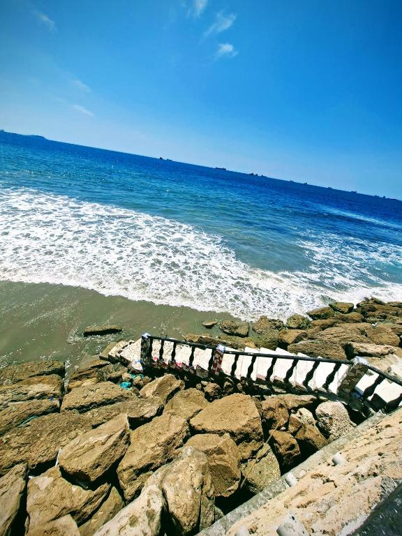 a pier on the rocks near the ocean at Suite frente al Mar con Acceso Directo a la Playa in Ballenita