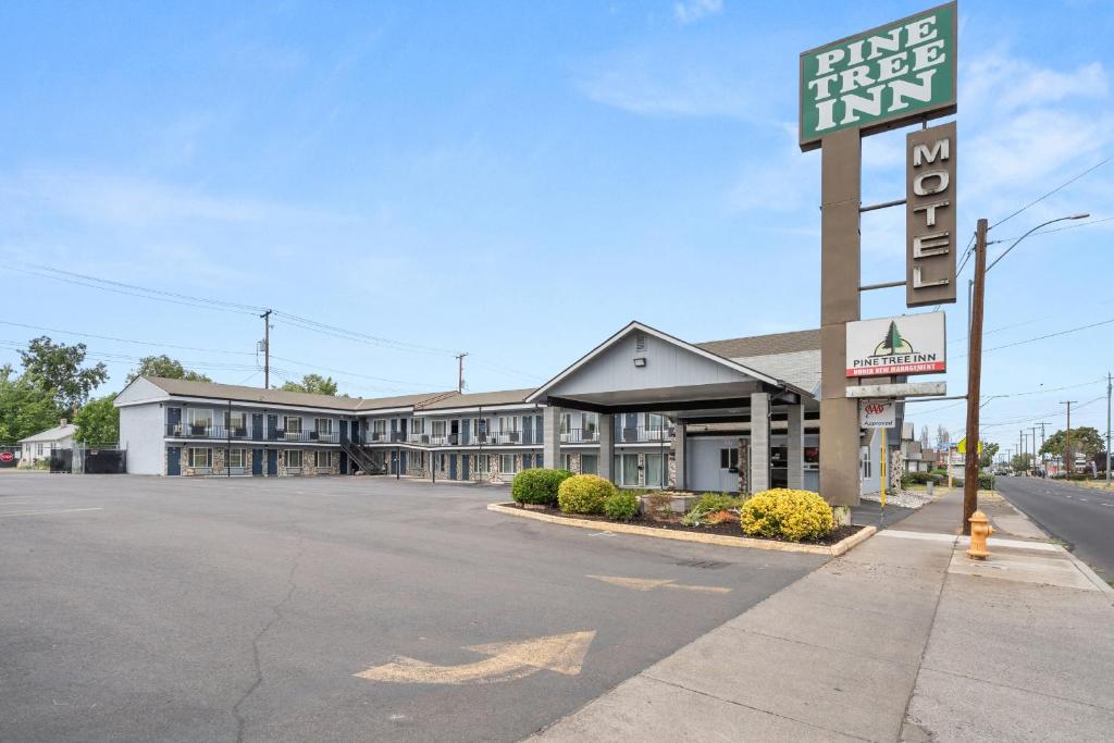 a building with a sign for a hotel at Pine Tree inn in Medford