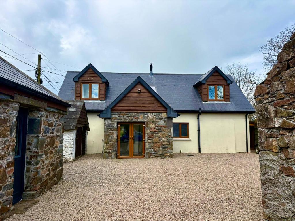 a large white house with a gambrel roof at An Cnocán in Limerick