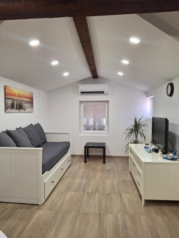 a living room with a bed and a table at Villa Ivana in Koper