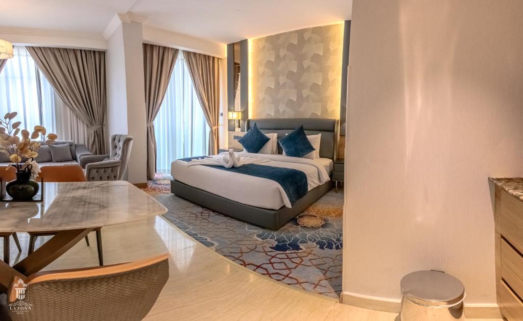 a bedroom with a bed and a living room at La Zona Continental Hotel in Dubai