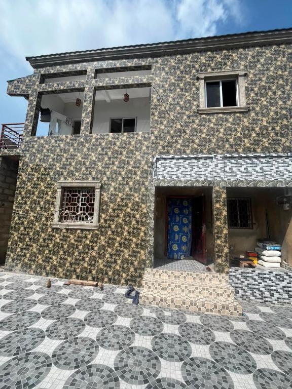 a house with a blue door and a tile floor at Kala's apartment farato in Medina Suware Kunda