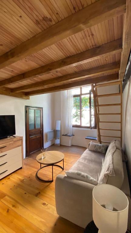 a living room with a couch and a table at Studio in Saint-Martin-Vésubie