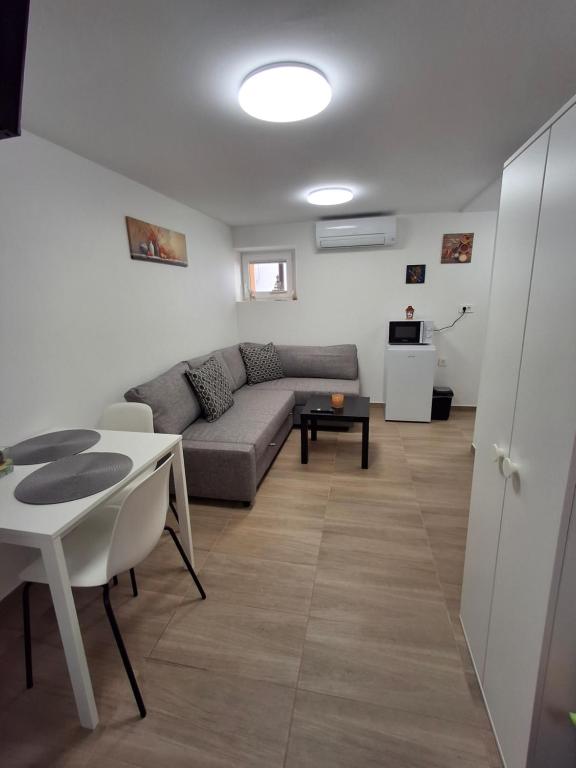 a living room with a couch and a table at Villa Ivana in Koper