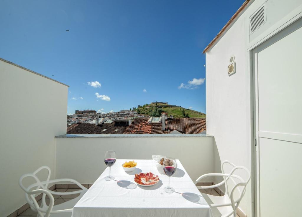 a table and chairs on a balcony with a view at Principado de Aracena I in Aracena