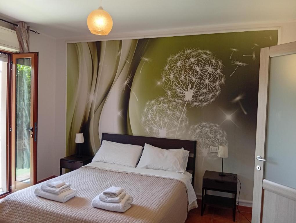 a bedroom with a bed with two towels on it at Mimì Home in Isernia