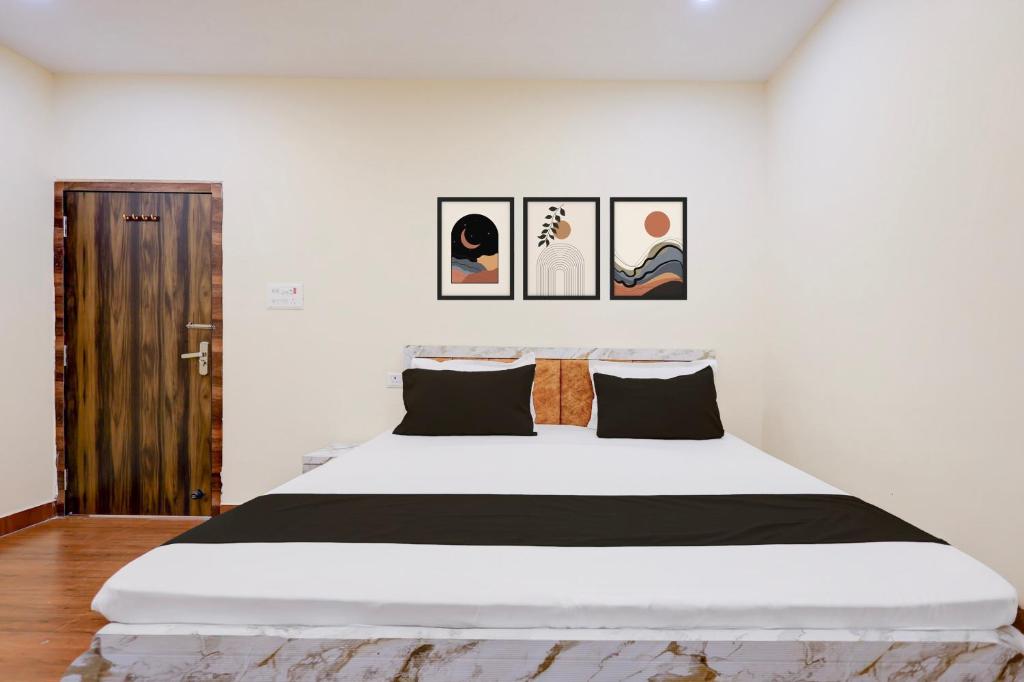 a bedroom with a large bed with four pictures on the wall at Hotel O Swarg Paradise Inn in Rānchī