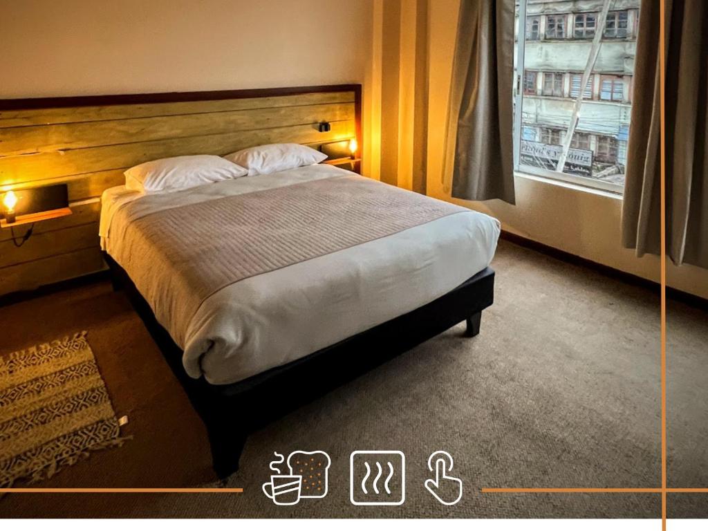 a bedroom with a large bed with a window at Noth Central in Osorno