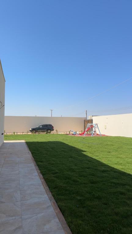 a car parked in a field with a playground at أستراحة الهوني in Banghāzī