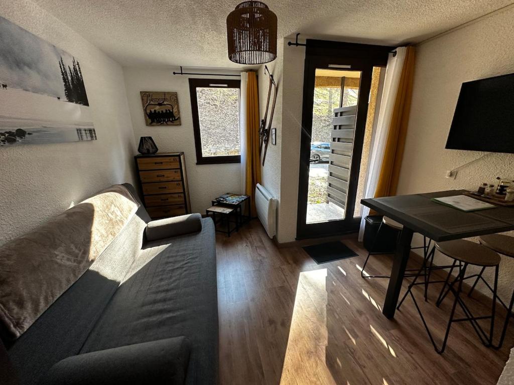 a living room with a couch and a table at Chalet Puy-Saint-Vincent m from slopes in Puy-Saint-Vincent