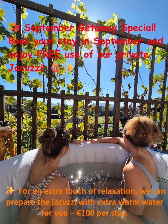 two women sitting in a hot tub in the water at RELAX HOUSE Kolpa view Podzemelj in Gradac
