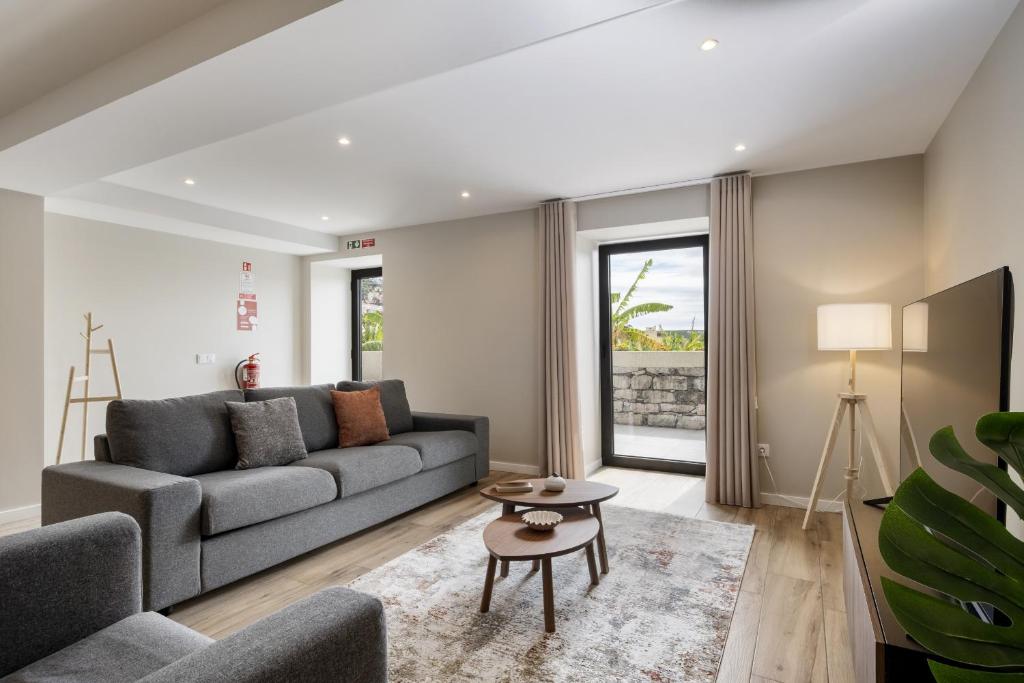 a living room with a couch and a table at Oceanea Apartment by Homie in Santa Cruz
