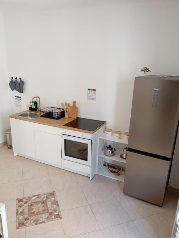 a kitchen with a refrigerator and a counter top at Suite 93 in Mola di Bari