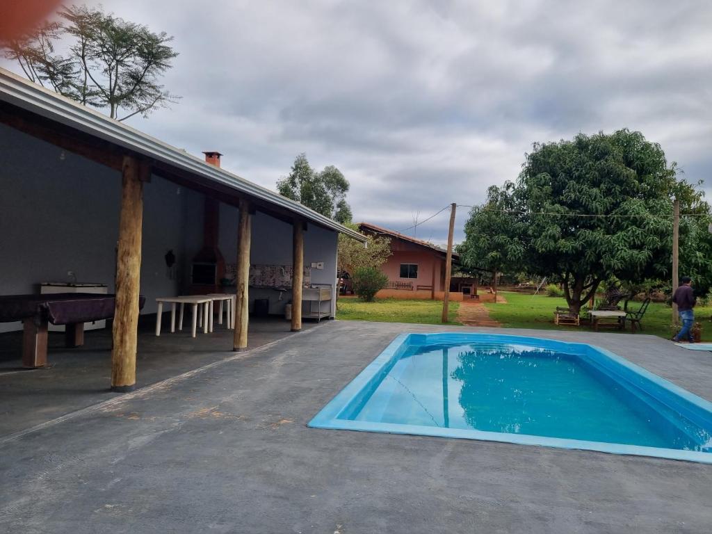 a swimming pool in front of a house at KmX in Campo Grande