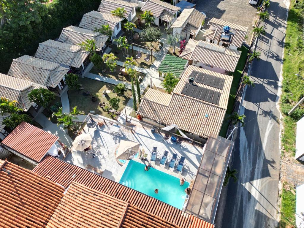 an overhead view of a swimming pool with roofs at Vilarejo Cipó in Serra do Cipo