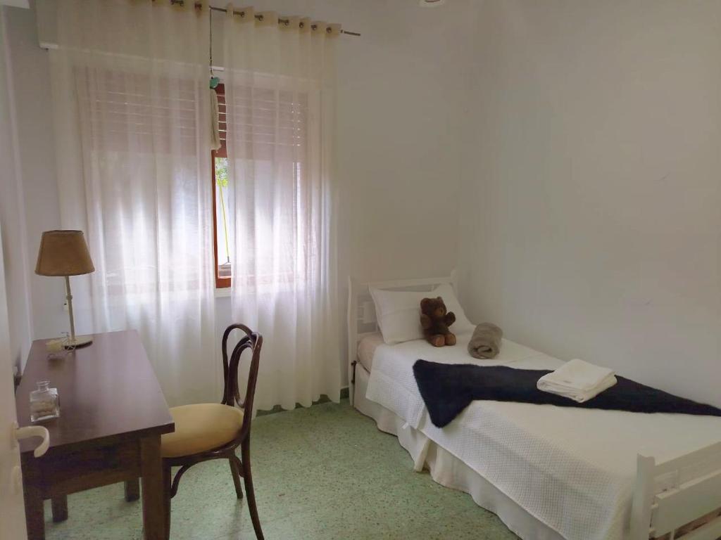 a bedroom with a teddy bear sitting on a bed at Petit Margaret in Santa Rosa