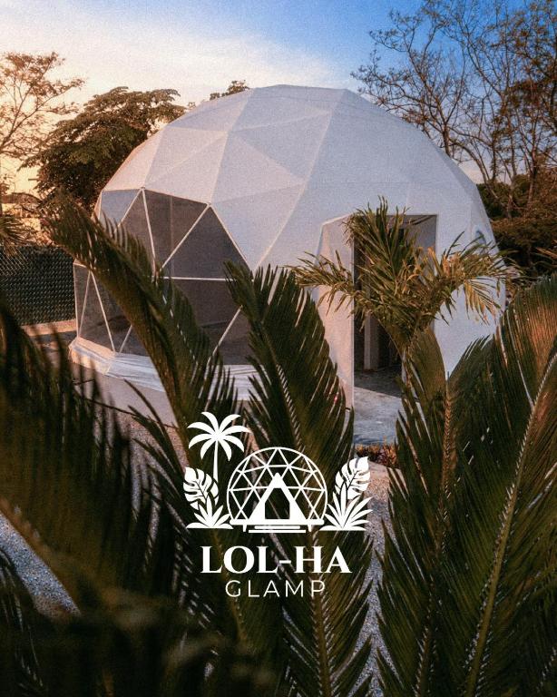 a domed building with palm trees in front of it at Lol-ha glamp in Temixco