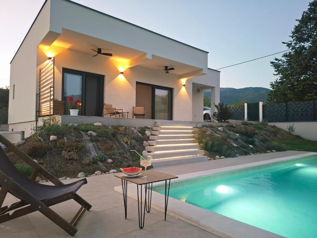 a house with a swimming pool next to a house at Villa Velaris Mostar in Mostar