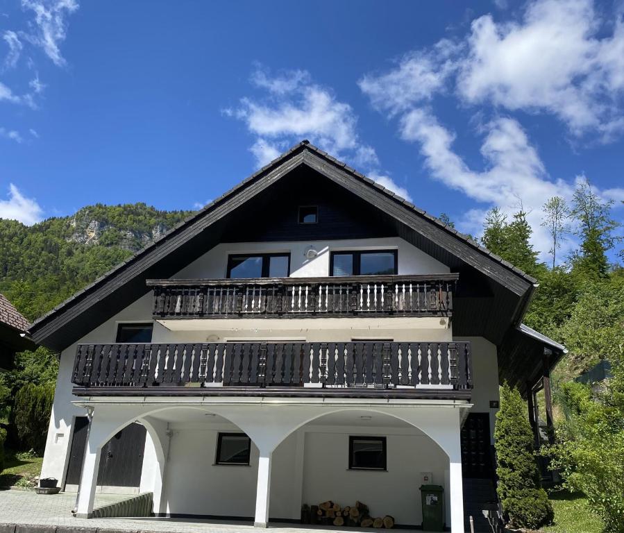 a house with a balcony on top of it at Holiday Chalet near Bled in Obrne