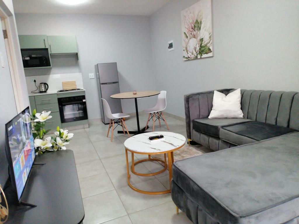 a living room with a couch and a table at Your Exclusive PMB Escape in Pietermaritzburg
