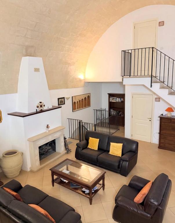 a living room with couches and a fireplace at Residence Del Casalnuovo in Matera